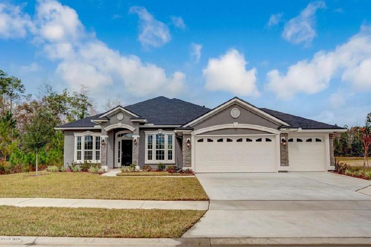 A two-story house with a garage and a driveway.