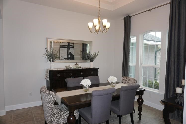 A dining room with a wooden table and chairs.