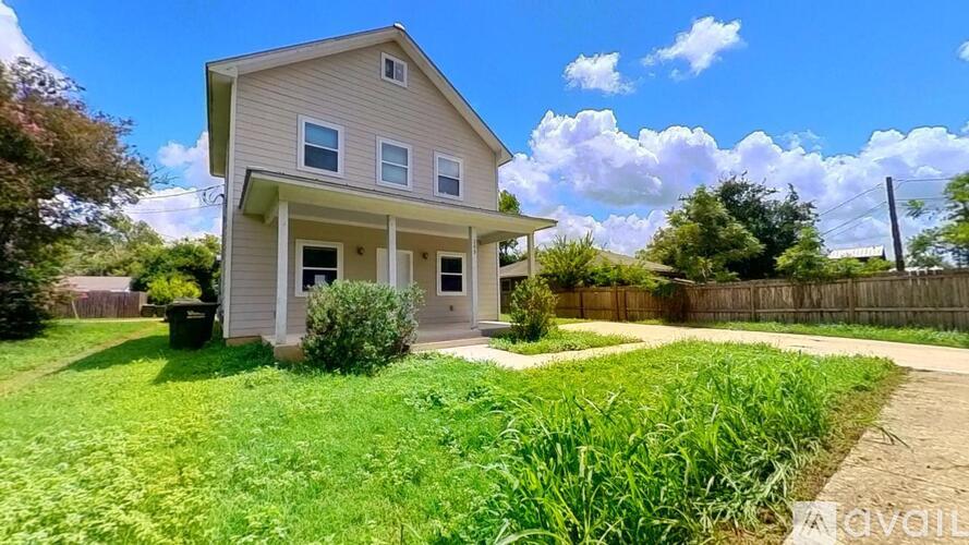 A house with a well-maintained lawn in front of it.