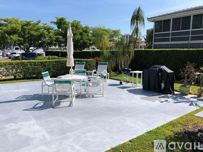 A pool area with chairs and a table.