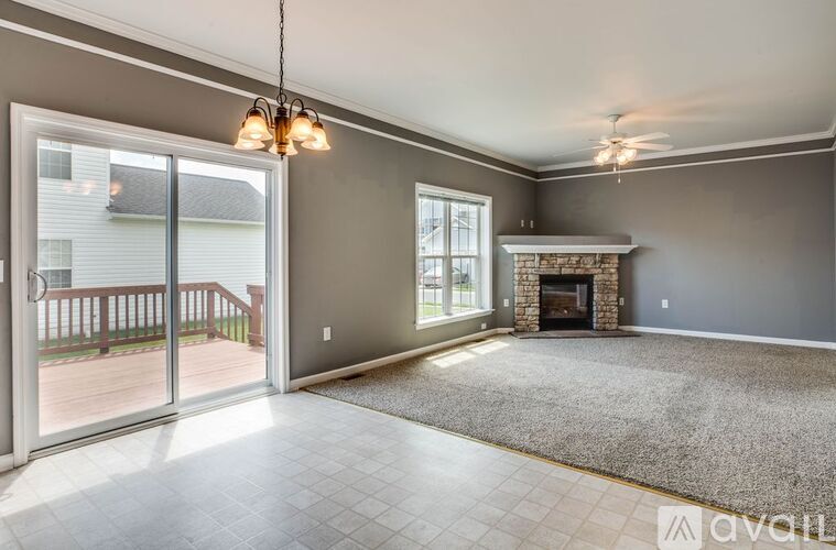 A living room with a fireplace and sliding glass doors.