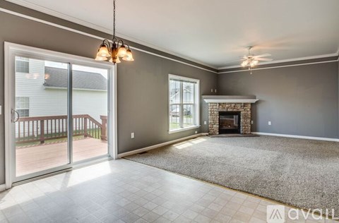A living room with a fireplace and sliding glass doors.