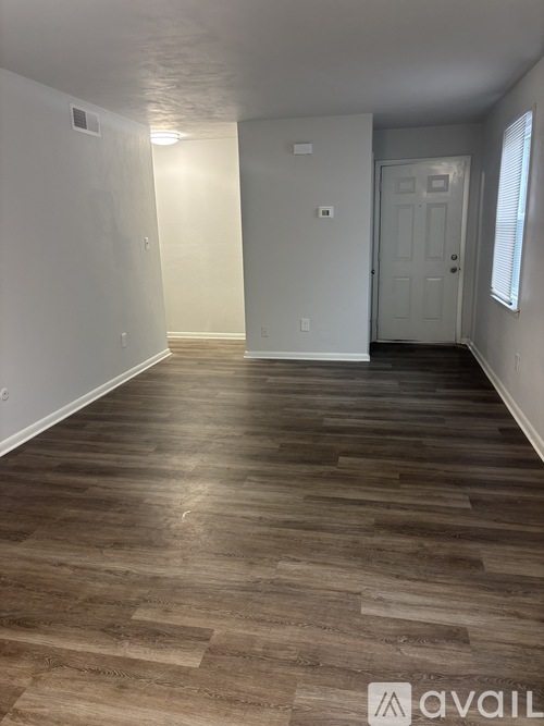 A room with a chandelier and a doorway leading to another room.
