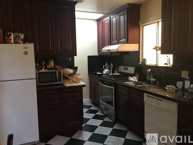 A kitchen with a black and white checkered floor.