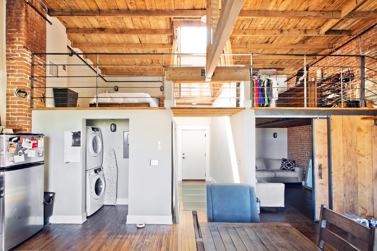 A kitchen with a washing machine and dryer in it.