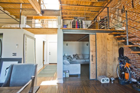 A living room with a couch and a bicycle.