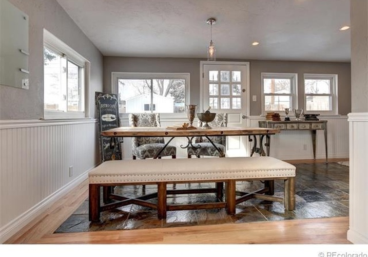 A dining room with a wooden table and bench.