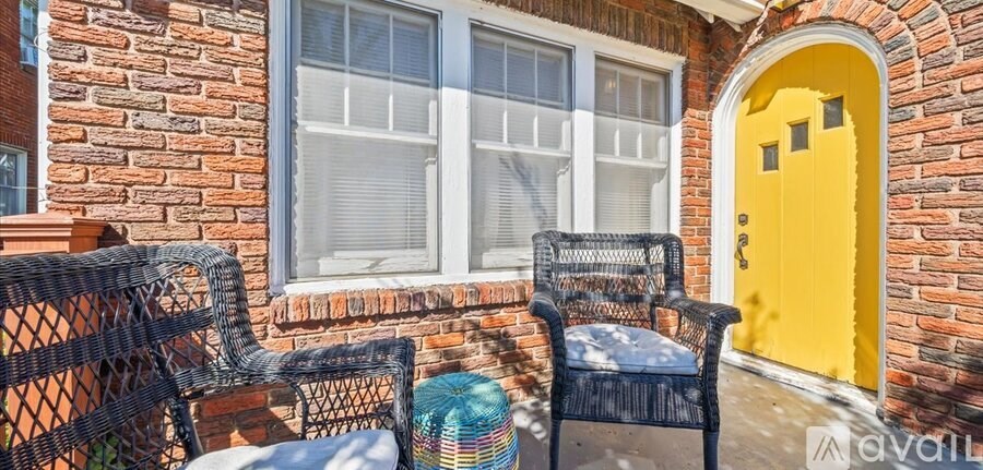A yellow door is on a brick building.