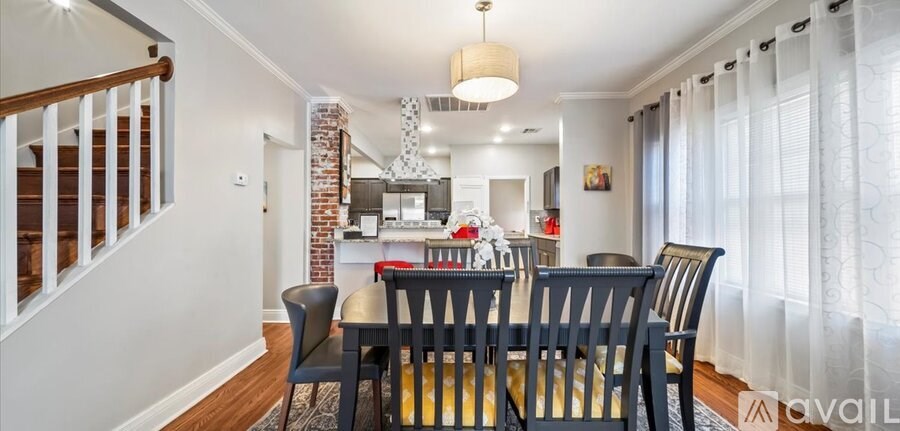 A dining room with a table set for four.