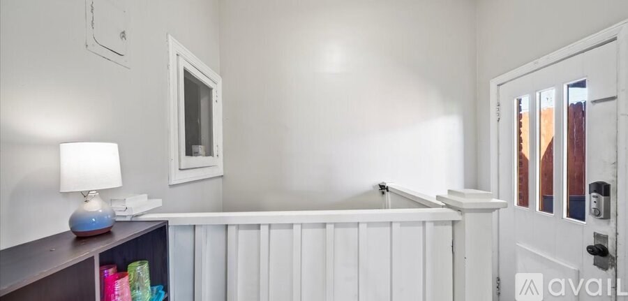 A white door is open to a hallway.