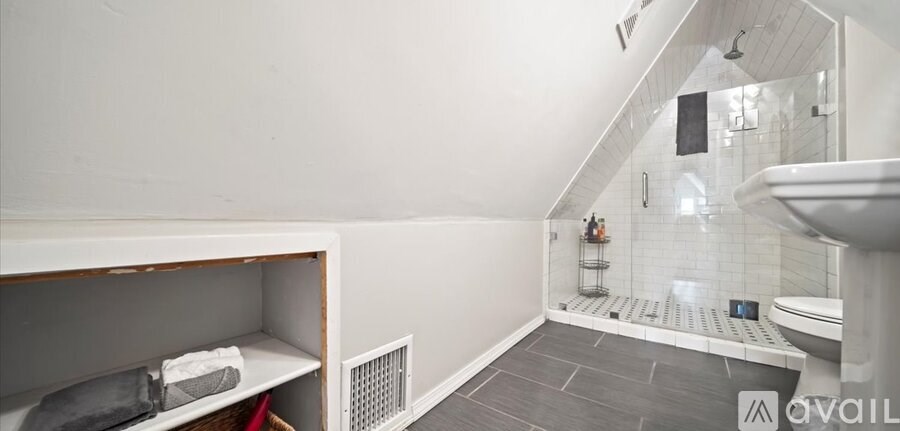 A bathroom with a walk-in shower and a toilet.