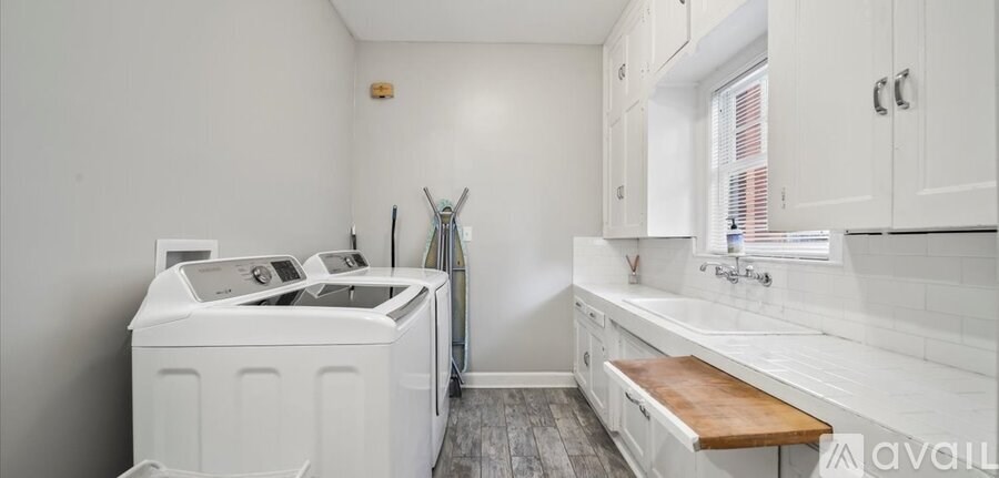 A small laundry room with a washer and dryer.