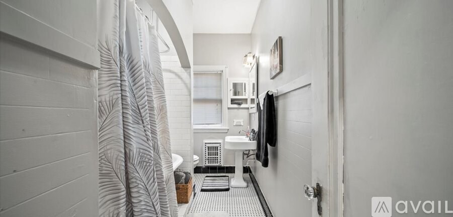 A bathroom with a white towel hanging on the wall.