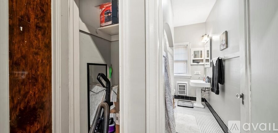 A small, white bathroom with a toilet, sink, and a mirror.