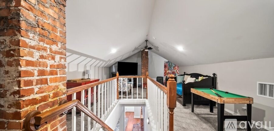 A room with a pool table and a couch.