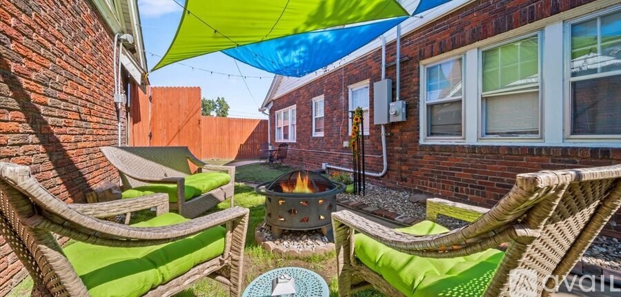 A patio with a fire pit and seating area.