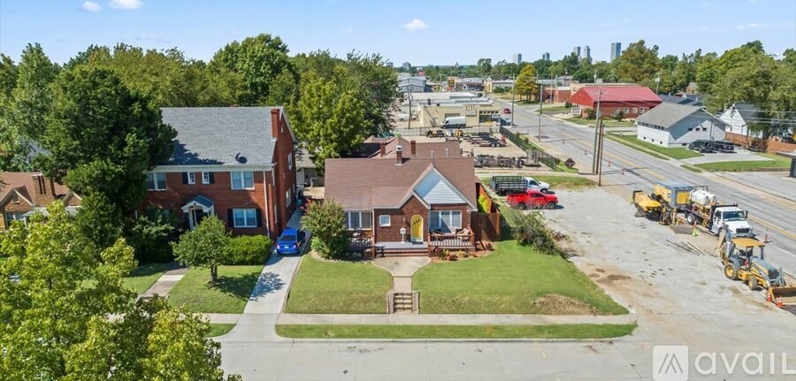 A suburban street with houses and a construction site.