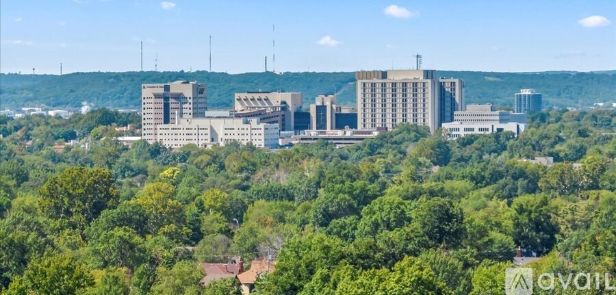 A large industrial complex surrounded by trees.