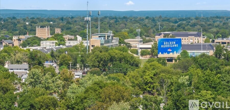 A large blue sign with the words "Golden Hurricane" on it is visible from a distance in a cityscape.