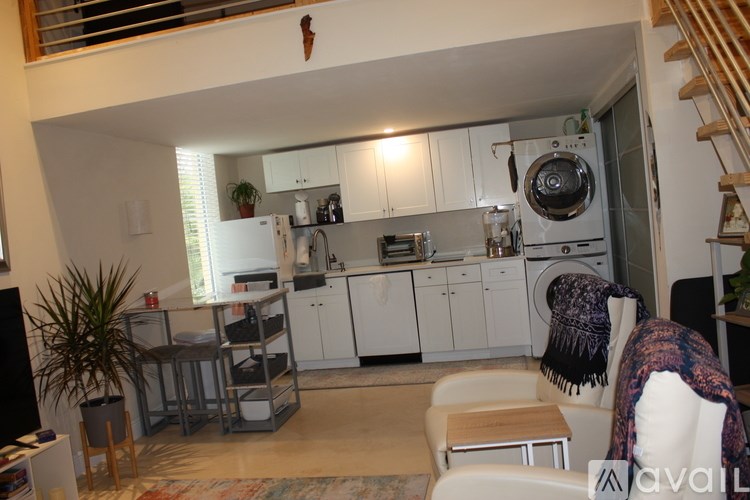 A kitchen with white cabinets and a stove top oven.