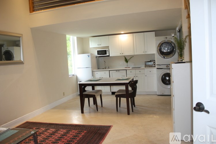 A kitchen with a table and chairs in the middle of the room.