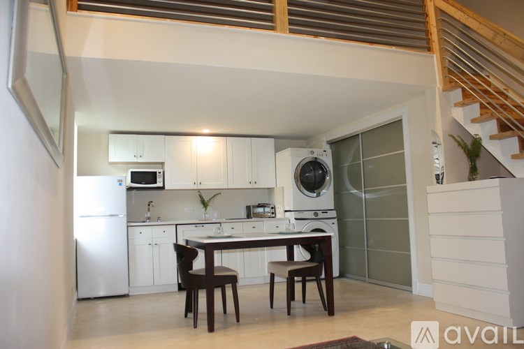 A kitchen with a table and chairs in the middle of it.
