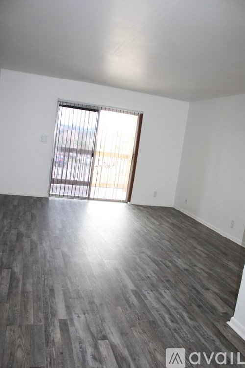 A kitchen with white cabinets and a stove top oven.