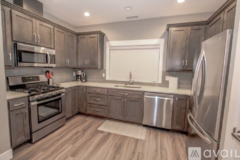 A kitchen with wooden cabinets and stainless steel appliances.