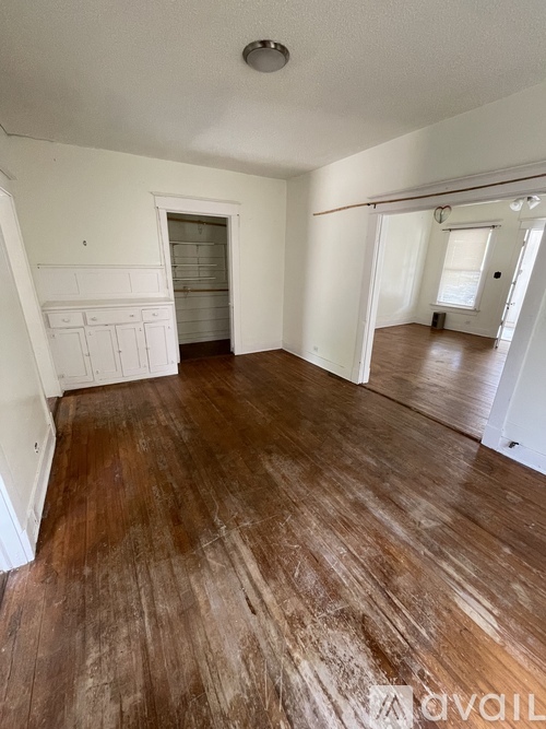 A room with wooden floors and white walls.