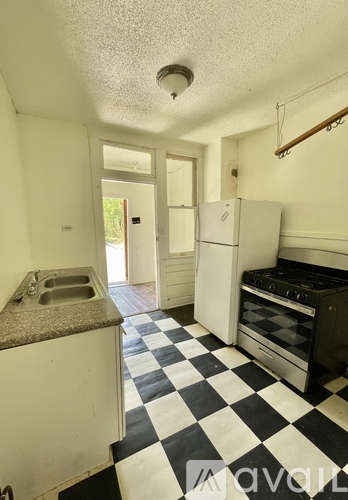 A kitchen with black and white checkered floor.