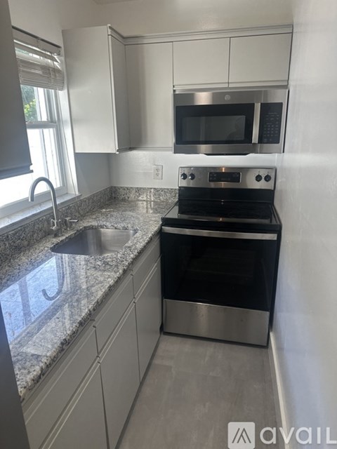 A kitchen with granite countertops and stainless steel appliances.