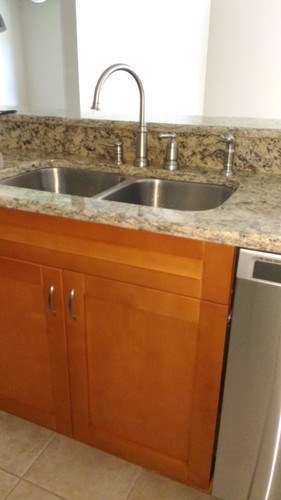 A kitchen with a sink and a dishwasher.
