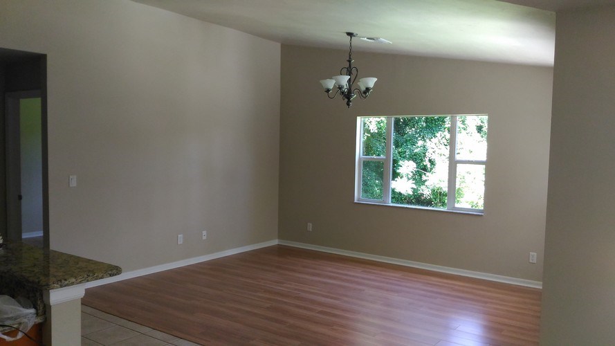 A room with a wooden floor and a window.