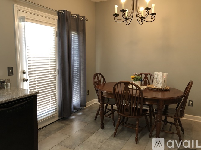 A dining room with a table set for four.