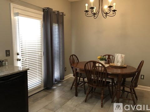 A dining room with a table set for four.