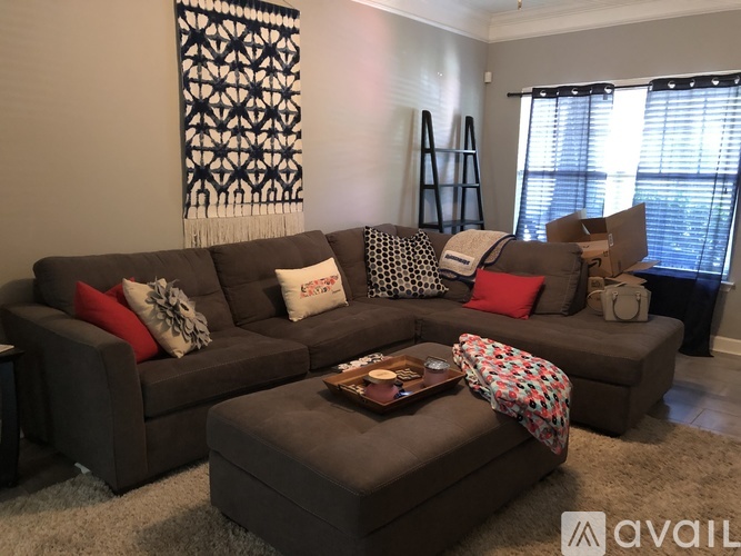 A living room with a grey couch and a coffee table.