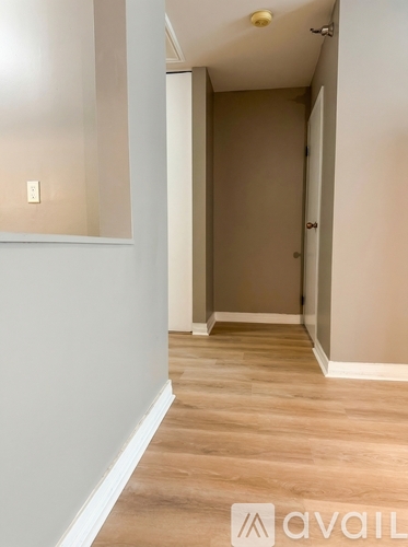A living room with brown walls and a large window.
