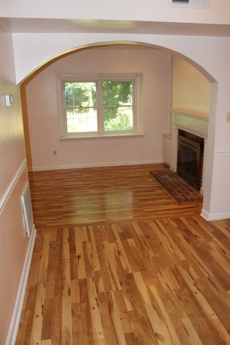 A room with wooden floors and a fireplace.
