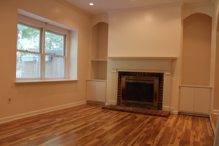 A room with a fireplace and a window.