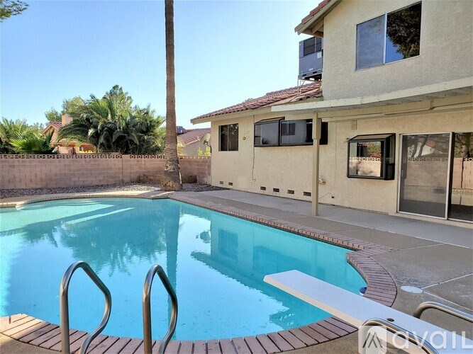 A swimming pool with a wooden deck and steps leading into the water.