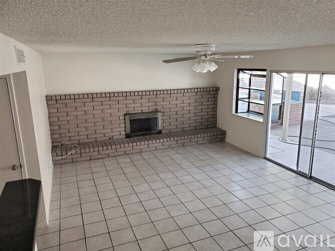 A living room with a fireplace and sliding glass doors.