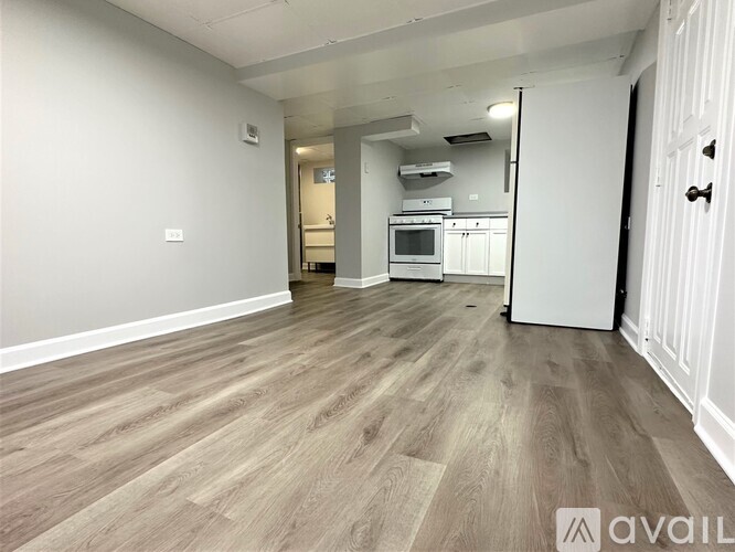A kitchen area with a microwave, oven, and refrigerator.