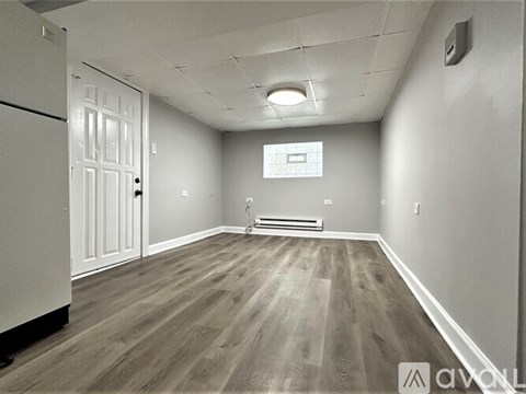 A room with a white door and a window with a white frame.
