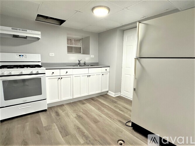 A kitchen with white appliances and cabinets.