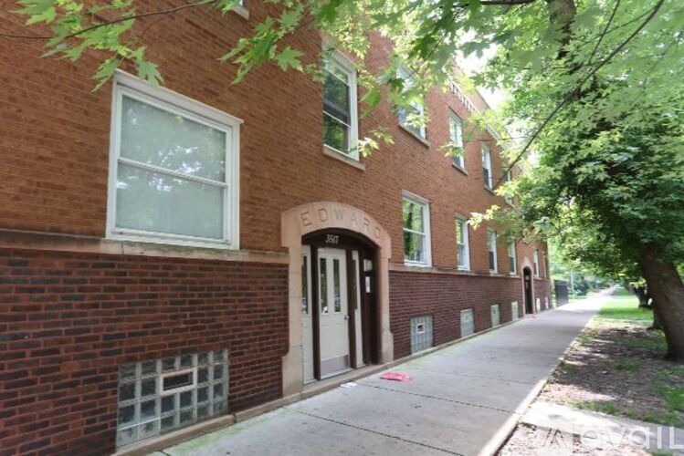 A brick building with a sign that says "EDWARD" on it.