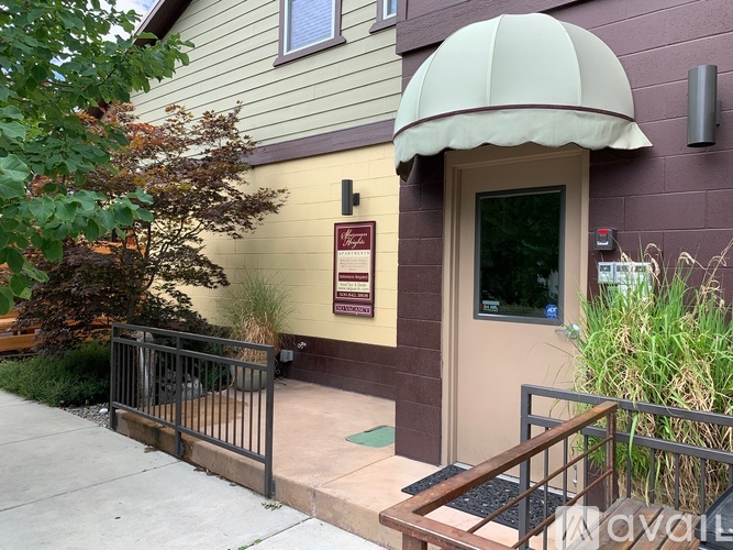 A building with a brown door and a sign on the wall.