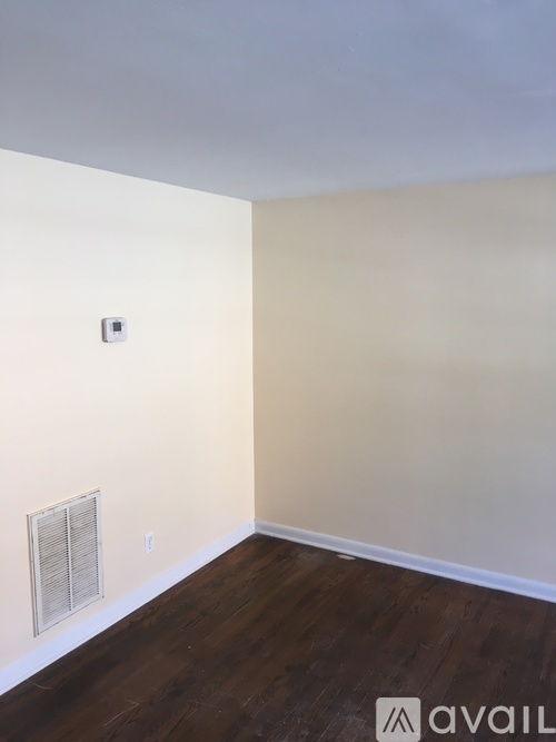 A room with a light switch and a window.