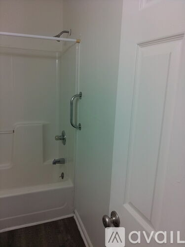 A white door with a silver handle is on the right side of the image.