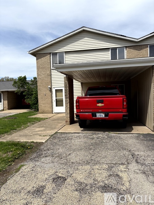 A red truck is parked in a garage.