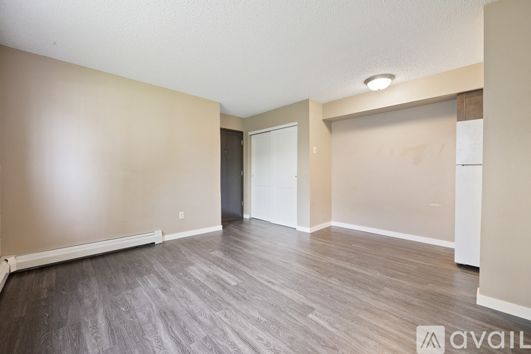 A spacious room with a grey floor and white walls.